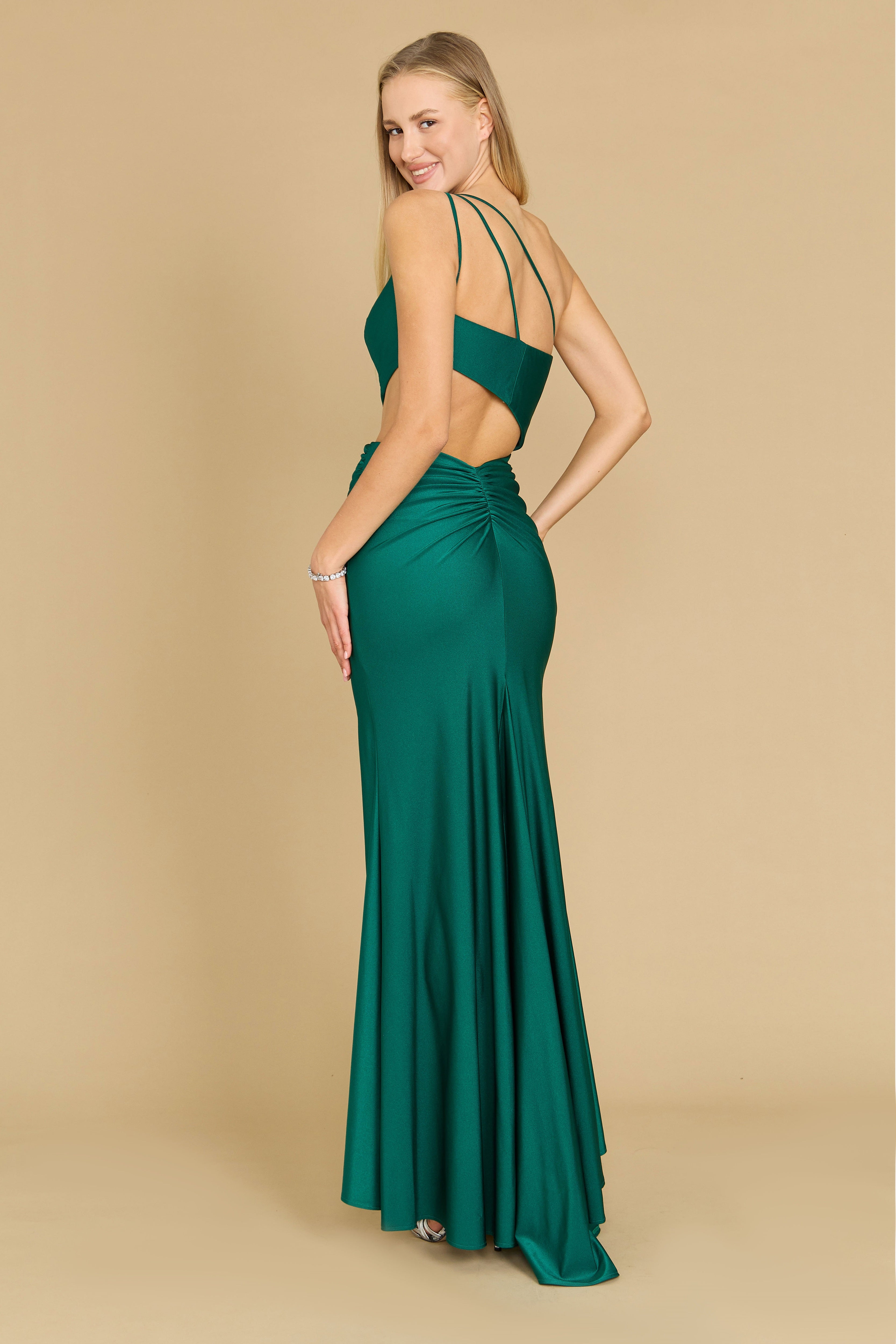 A stunning emerald green prom dress featuring elegant side cutouts, showcasing a blend of sophistication and allure, perfect for a formal evening event.