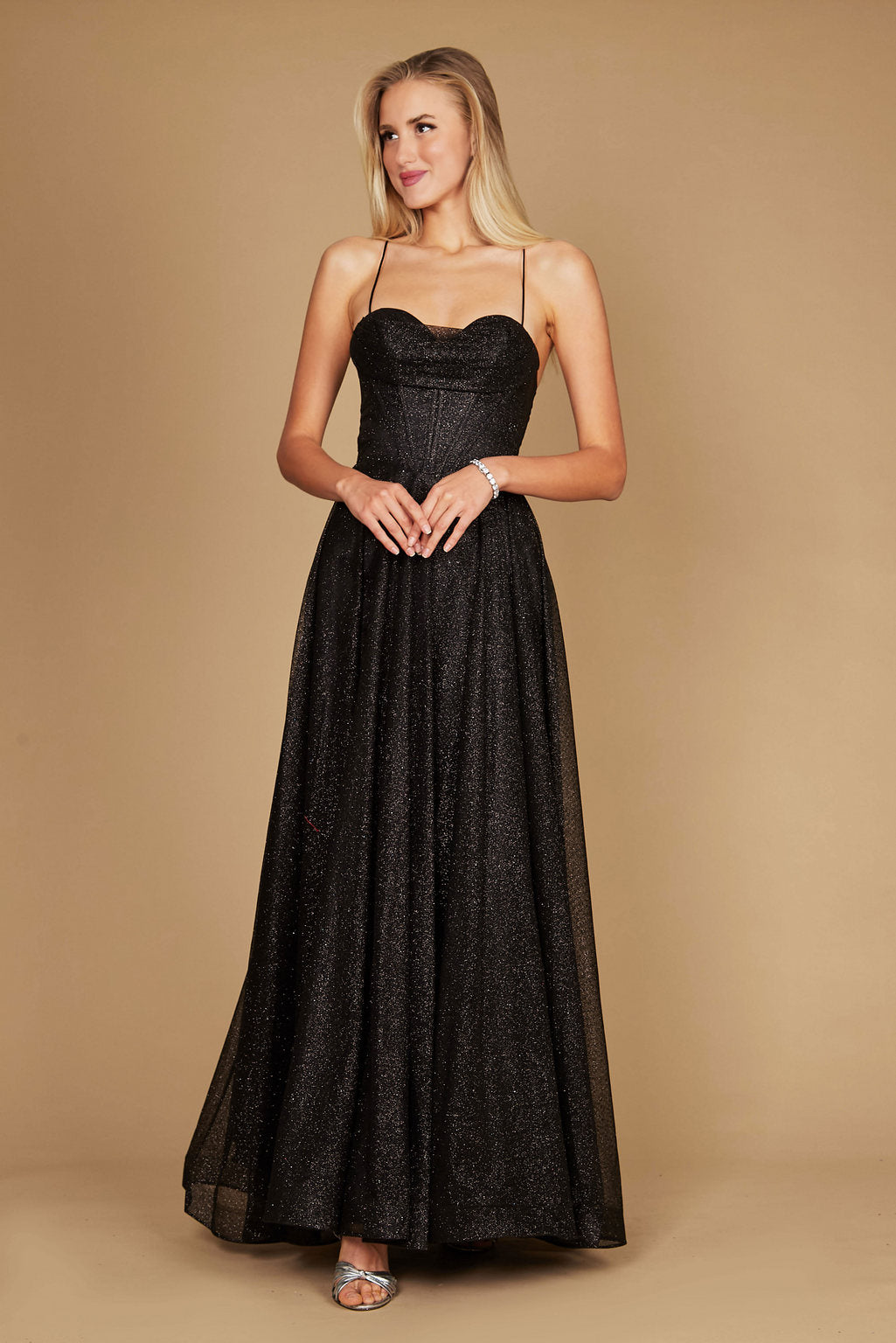 A stunning black prom dress featuring a long, sparkling cowl neckline and a fitted corset bodice, elegantly flowing into a full skirt that shimmers with every movement.