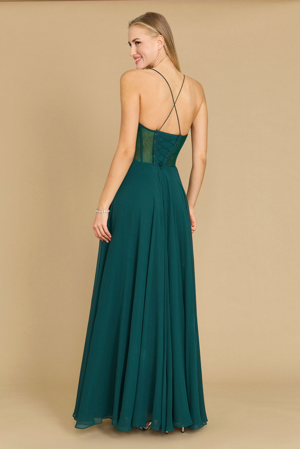 Elegant long chiffon corset formal prom dress in a rich emerald green, featuring a fitted bodice and flowing skirt, perfect for a glamorous evening event.
