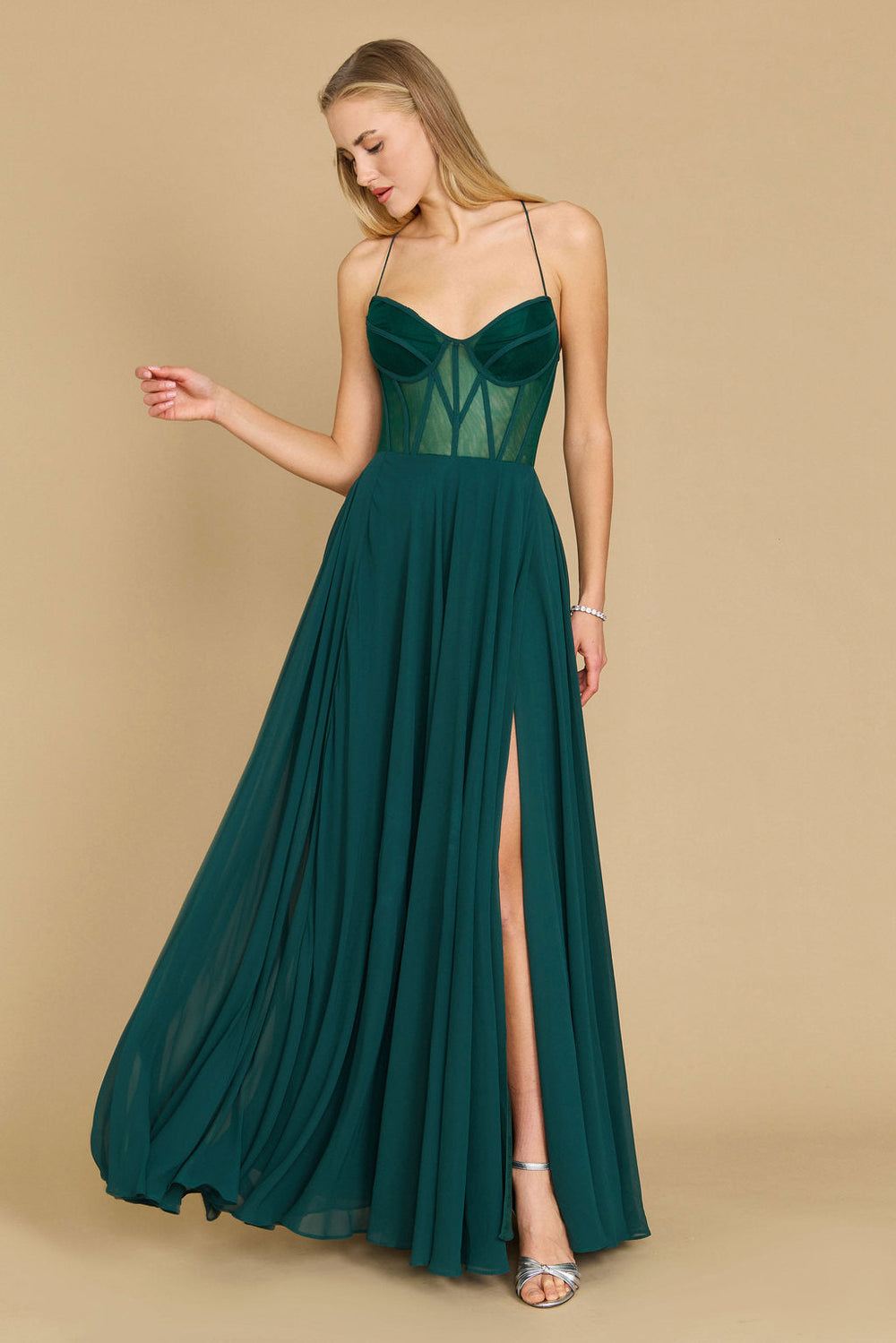 Elegant long chiffon corset formal prom dress in a rich emerald green, featuring a fitted bodice and flowing skirt, perfect for a glamorous evening event.