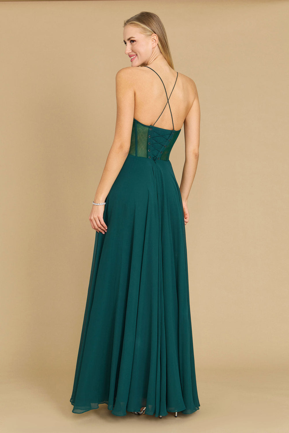 Elegant long chiffon corset formal prom dress in a rich emerald green, featuring a fitted bodice and flowing skirt, perfect for a glamorous evening event.