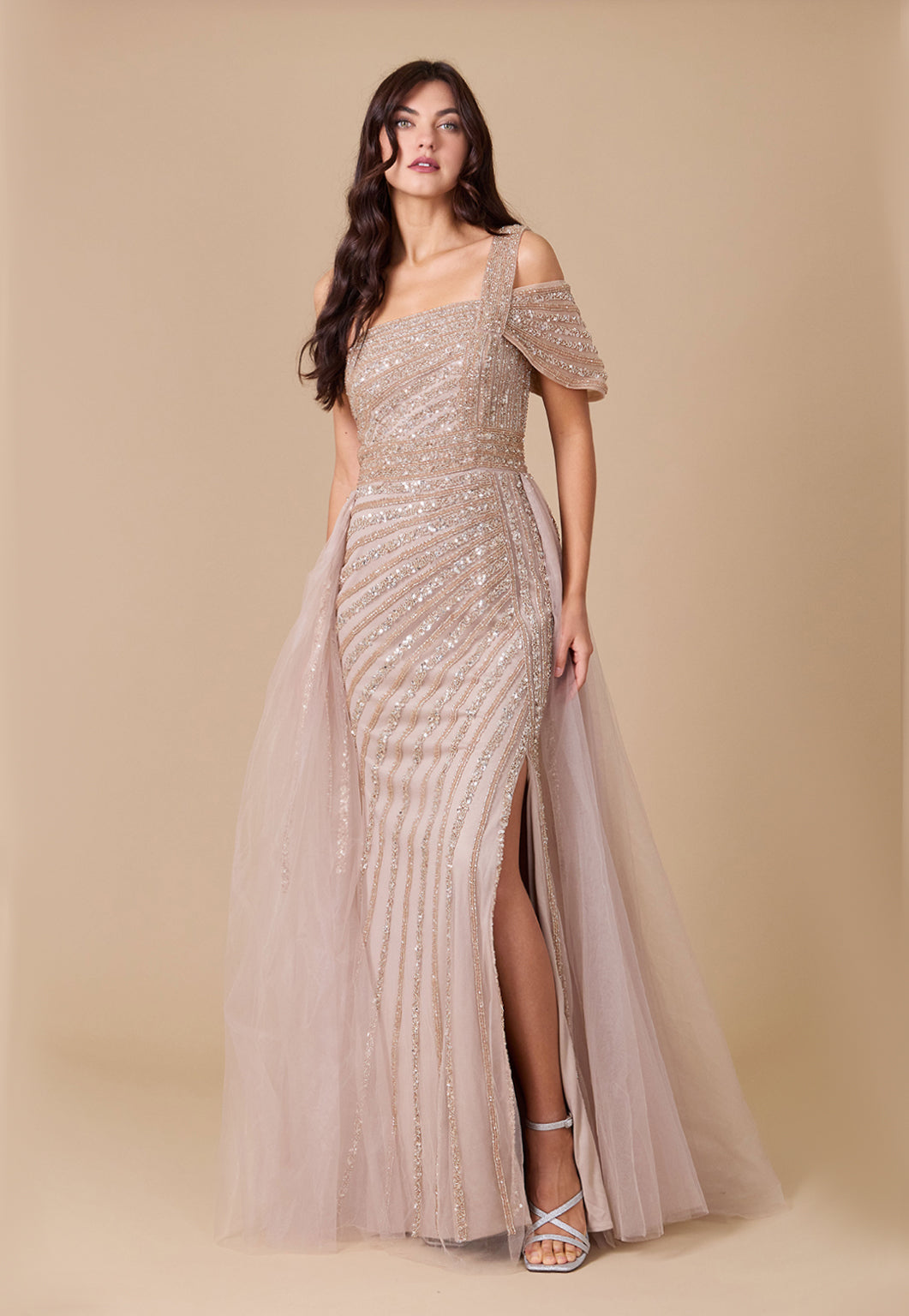 A stunning one-shoulder formal couture dress adorned with intricate hand-beaded details, showcasing elegance and sophistication.